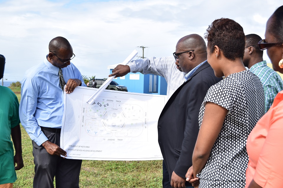 Prime Minister Harris looking at designs for the Kids' Area at Boyd's Playing Field