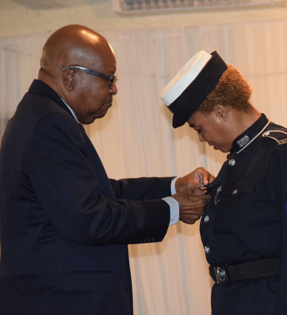Constable Ornette Jeffers being presented with Her Majesty's Diamond Jubilee Medal