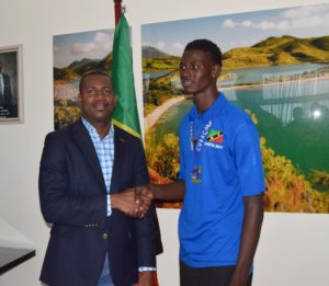 Athlete Jermaine Francis sports his gold medal while greeting Deputy PM Richards 