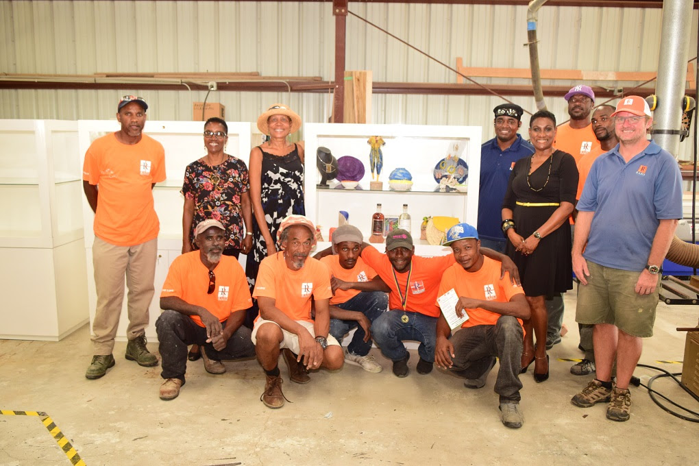 MINISTRY OF TOURISM ACCEPTS ARTISANS DISPLAY CASES AS PART OF COMMUNITY AND HERITAGE TOURISM EFFORTS PS CARLENE HENRY-MORTON (2ND FROM RIGHT) AND MINISTRY OFFICIALS POSE WITH RAZO CONSTRUCTION WORKERS